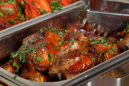 A delicious meal: lamb chops with tomato sauce and parsley.の写真素材