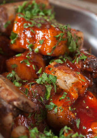 A delicious meal: lamb chops with tomato sauce.の写真素材