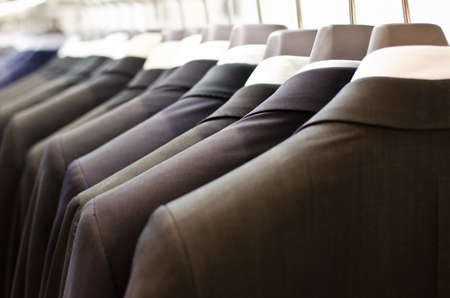 Men suits hanging in a clothing store.の写真素材
