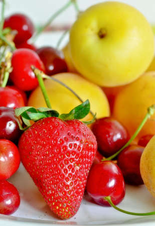 Fresh summer fruits: cherries,apricots and strawberries.の写真素材