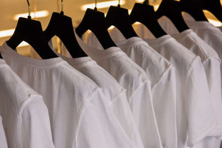 White t-shirts in a shopの写真素材