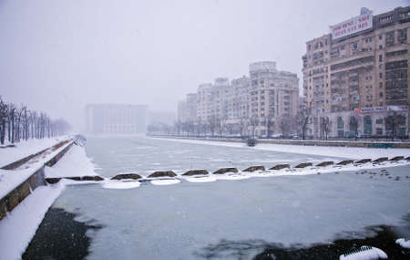 Bucharest, Romania â January 26, 2014: A street in Bucharest center after massive snowing. Heavy snow caused traffic chaos in Romania, much of the traffic in urban Bucharest was jammed.のeditorial素材
