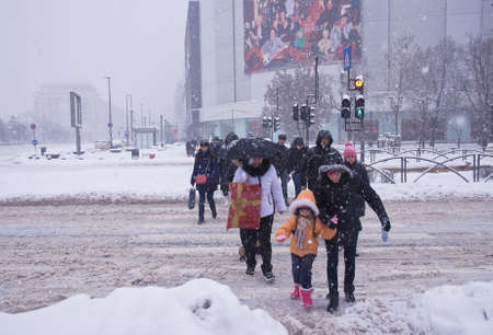 Bucharest, Romania â January 26, 2014: A street in Bucharest center after massive snowing. Heavy snow caused traffic chaos in Romania, much of the traffic in urban Bucharest was jammed.のeditorial素材
