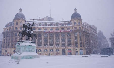 Bucharest, Romania â January 26, 2014: A street in Bucharest center after massive snowing. Heavy snow caused traffic chaos in Romania, much of the traffic in urban Bucharest was jammed.のeditorial素材