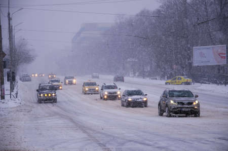 Bucharest, Romania â January 26, 2014: A street in Bucharest center after massive snowing. Heavy snow caused traffic chaos in Romania, much of the traffic in urban Bucharest was jammed.のeditorial素材