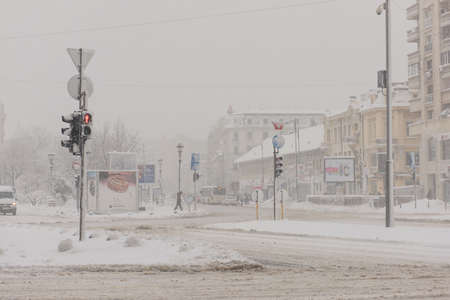 Bucharest, Romania â January 17, 2016: Bucharest downtown after massive snowing and restricted traffic, Unirii Square(Piata Unirii) and city center neighborhood.のeditorial素材