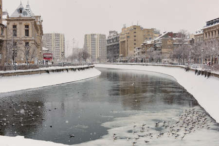 Bucharest, Romania â January 17, 2016: Dimbovita river and city center neighborhood in Bucharest downtown after massive snowing.のeditorial素材