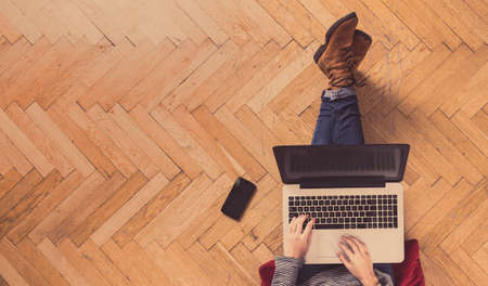 Modern workspace - girl with laptop working.の写真素材