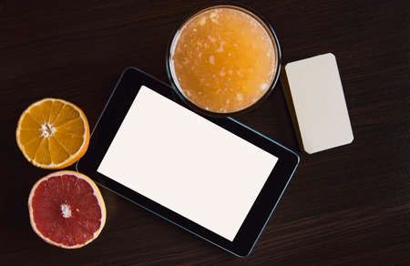 Tablet, smartphone and glass of ornage juice.の写真素材