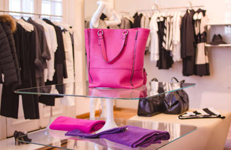 Pink women handbag in a clothing fashion store.の写真素材