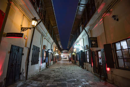 Bucharest, Romania - February 10, 2016: Narrow street in Bucharest city center at night.のeditorial素材