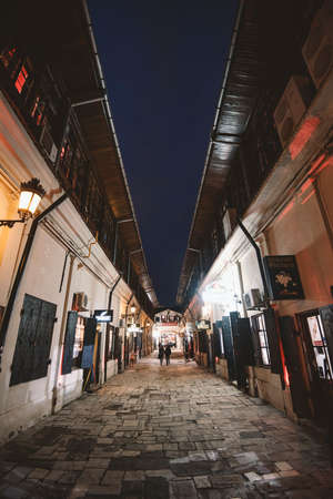 Bucharest, Romania - February 10, 2016: Narrow street in Bucharest city center at night.のeditorial素材