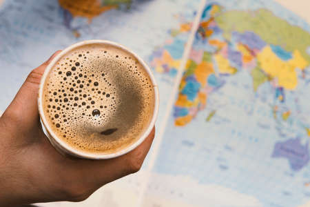 Planning a trip around the world with a coffeeの写真素材