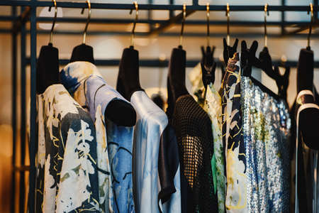 Clothes on racks in a fashion boutiqueの写真素材