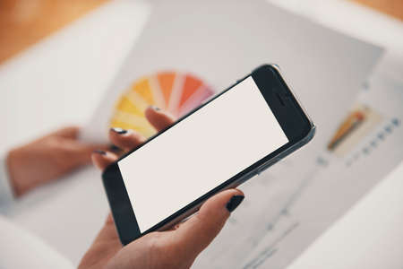 Woman with a smarphone and business charts.の写真素材