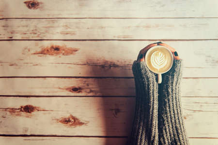 Girl holding a cup of coffee in winterの写真素材