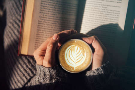 Girl reading and having a coffeeの写真素材