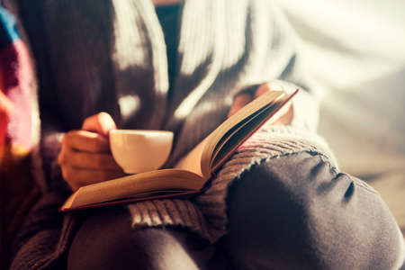 Girl reading and having a coffeeの写真素材