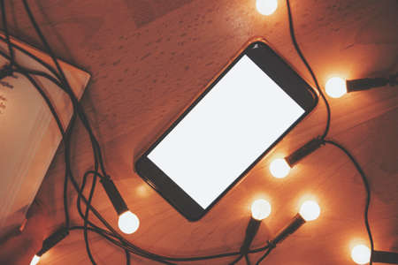 Smart phone in a cozy atmosphere.の写真素材
