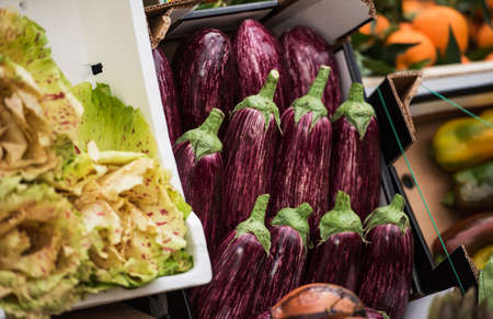 fresh eggplant and salad in a marketの写真素材