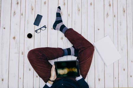 Man holding a Tablet device and browsingの写真素材