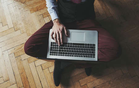 man working from a laptop at home - hipster look