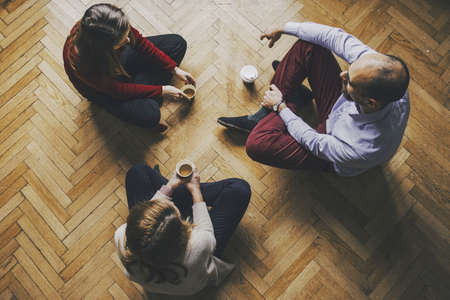 socializing concept - friends havind a coffee and talking