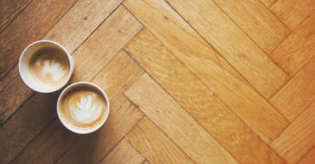 Two coffees on a floor background and a warm atmosphereの写真素材