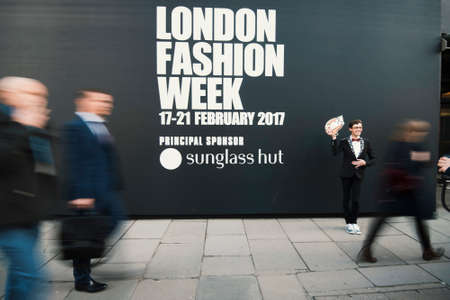 London, England â€“ February 17, 2017: People in motion at the entrance of London Fashion Week.