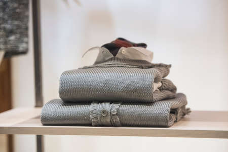 Men clothes on a shelf in a storeの写真素材