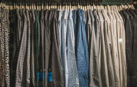 Men shirts on racks in a clothing shop in Londonの写真素材