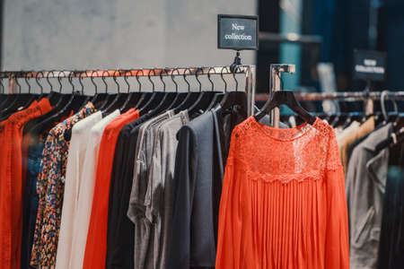 Women clothes on racks in a store in London.の写真素材