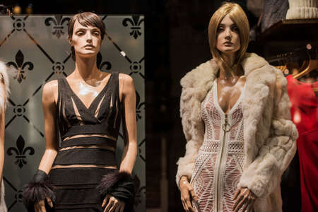 Mannequins in a storefront of an elegant store.