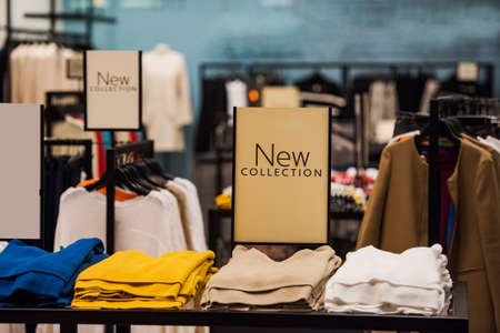 Stacks of clothes in a fashion storeの写真素材