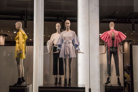 Women clothing store with mannequins in showcaseの写真素材