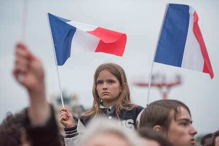 Paris, France - May 7, 2017: Crowds celebrate Macron's victory at the Louvre Museum after...