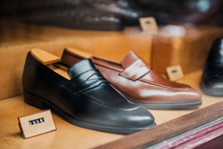 Men shoes in a luxury store in Paris.の写真素材