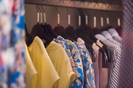 Fancy clothing on racks in a store in Paris.の写真素材