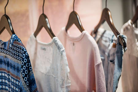 Woman clothing on racks in a store in Parisの写真素材