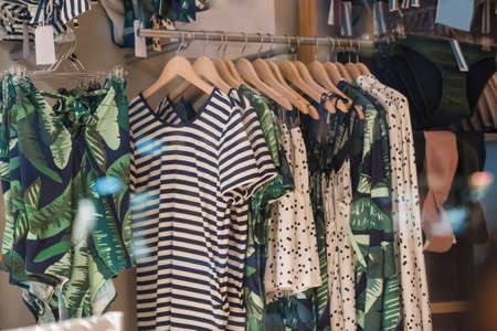 Fancy clothing on racks in a store in Paris.の写真素材