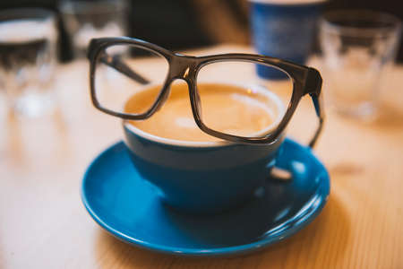 Smart coffee - coffee cup with glassesの写真素材