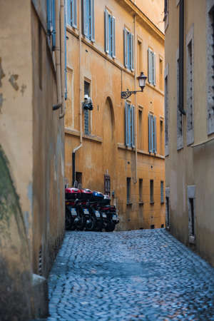 Rome cityscape - motor scooters on a narrow street.の写真素材