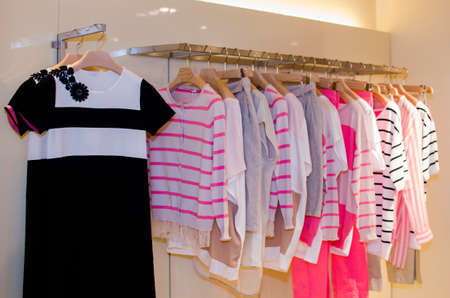Women clothes on racks in a fancy store.