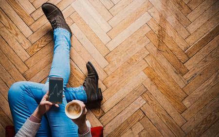 Browsing and taking a coffeeの写真素材