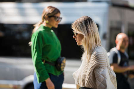 Milan, Italy - September 22, 2017: Woman with a fashionable look, poses for photographers before Armani Fashion Show at Milan Fashion Week - street style concept Spring/Summer 2018.のeditorial素材