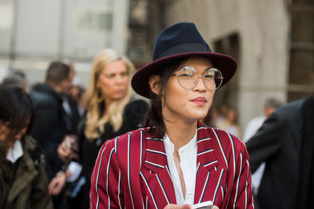 Milan, Italy - September 23, 2017: Fashionable girl posing during Milan Fashion Week - street style...