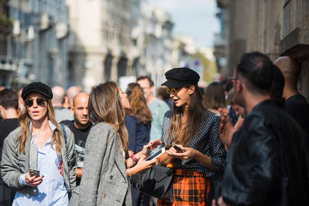 Milan, Italy - September 22, 2017: Beautiful girls in fashionable outfits, outside a fashion show, during Milan Fashion Week SS2018.のeditorial素材