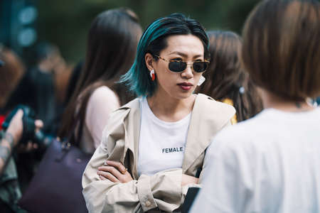 Milan, Italy - September 23, 2017: Asian girl with a stylish outfit posing on the street during Milan Fashion Week.のeditorial素材