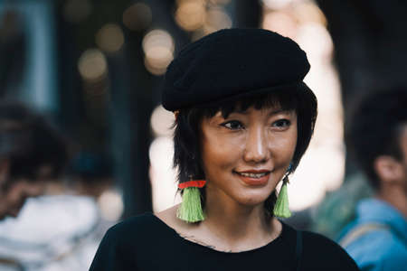 Milan, Italy - September 23, 2017: Asian girl with a stylish outfit posing on the street during Milan Fashion Week.のeditorial素材