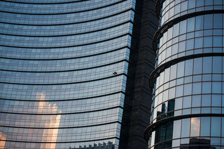 Corporate concept - detail of modern glass building in Milan